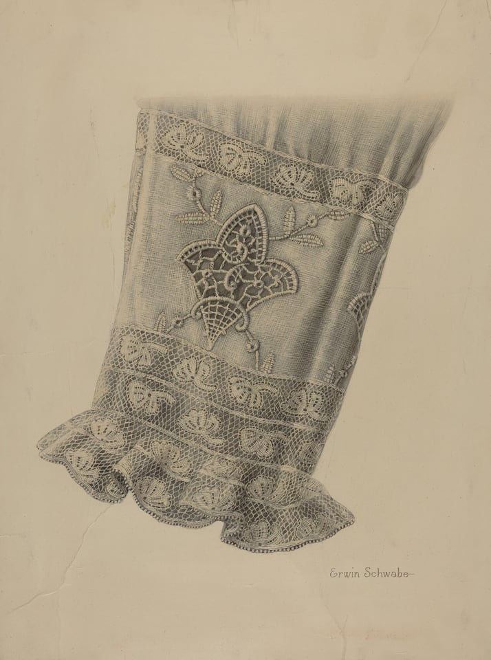 The image shows a lace-trimmed sleeve with a floral lace design in the center, primarily in shades of gray and off-white. The sleeve is positioned vertically in the center of the image, with the top slightly obscured by shadow and the ruffled lace edge at the bottom. The lace details are intricate and precise, enhancing the texture and complexity of the design.
