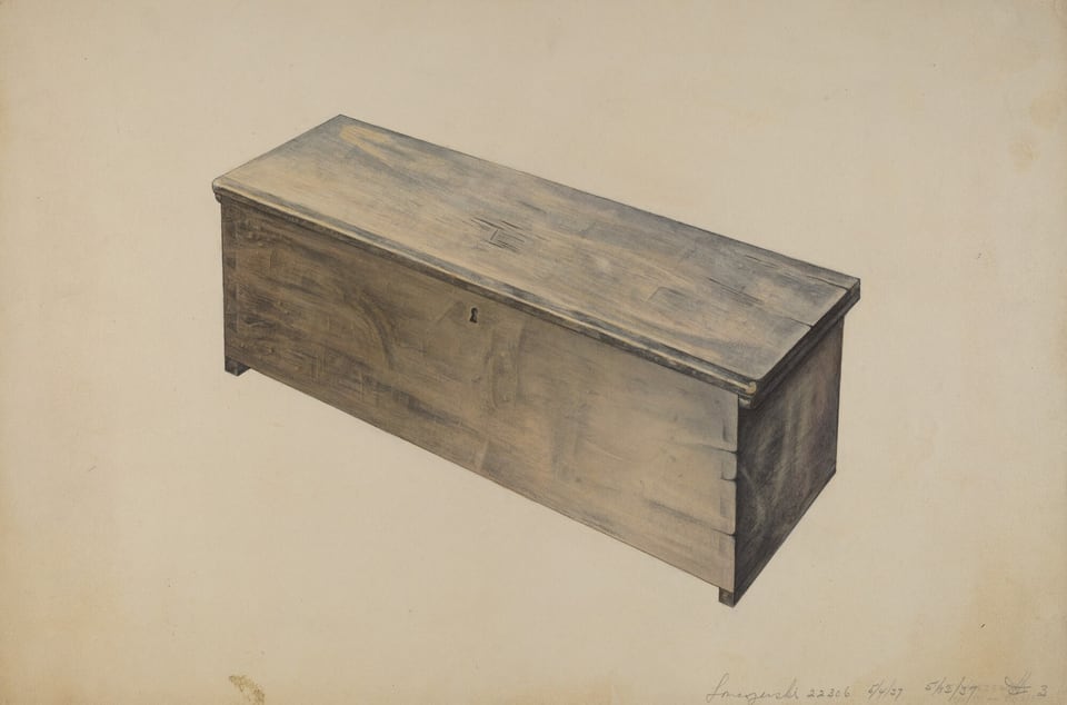 The image shows a large wooden chest with a rectangular design and a keyhole on its front panel. The chest has a weathered look in muted browns and grays. It is positioned in the center with its top, front, and side panels visible. The background is plain and light in color.