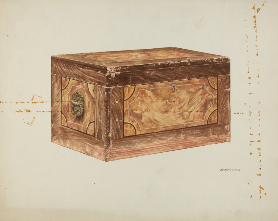 The image shows a large rectangular wooden box with decorative panels, a metal handle on the side, and a keyhole on the front panel.