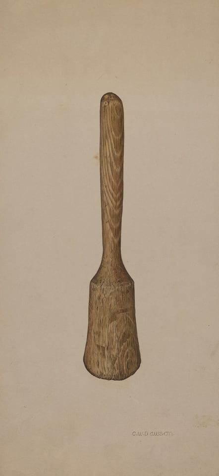 A wooden mallet is displayed on a beige background. The mallet has a rounded handle and a broad head, showcasing earthy brown tones with variations in the wood grain. Positioned centrally, the mallet stands upright in the image.
