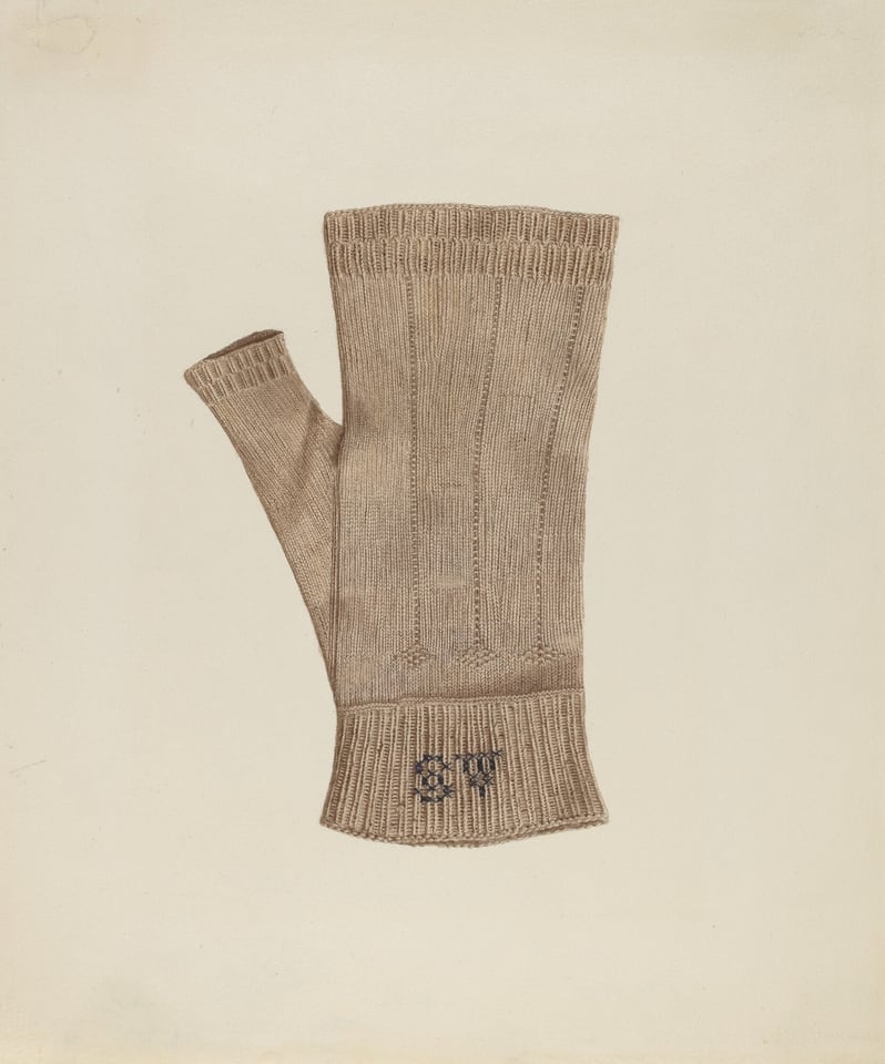 The image shows a beige knitted fingerless glove on a light-colored background. The glove is flat and displayed vertically, with the thumb-piece extending to the left. There is a subtle dark pattern or lettering at the base of the glove. The color palette is warm with beige tones against the light background, emphasizing the texture and design of the glove.