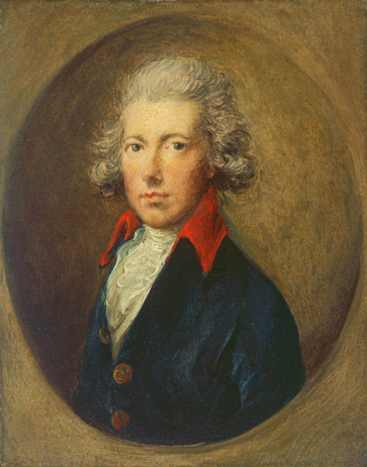 The image depicts a portrait of an individual with the upper half of their body visible. The person is facing forward with their head slightly turned to the side, looking directly at the viewer. They have a fair complexion, with distinct facial features, including a rounded face and closed lips. The hair is styled in an 18th-century manner, with curls around the ears. They are wearing a dark coat with red lapels and brass buttons, over a white shirt with ruffled details. There are no visible jewelry or objects in their hands. The background is a textured, earth-toned surface.