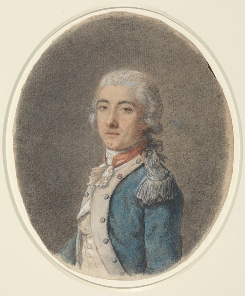 The image displays an oval portrait of a man's upper torso. He is turned slightly to the right, looking directly at the viewer with a composed expression. The man has pale skin, defined facial features, softly arched eyebrows, a subtle mustache, and styled hair in an 18th-century fashion. He wears a blue coat with white lapels, silver buttons, and a silver-fringed epaulet on the shoulder, along with a cravat and waistcoat. The background is a smooth, neutral gray.