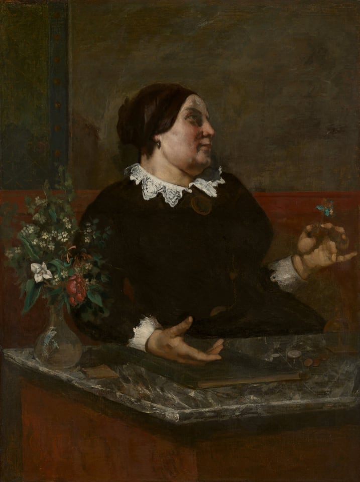 Dark portrait of older woman in black dress with lace collar, flowers.